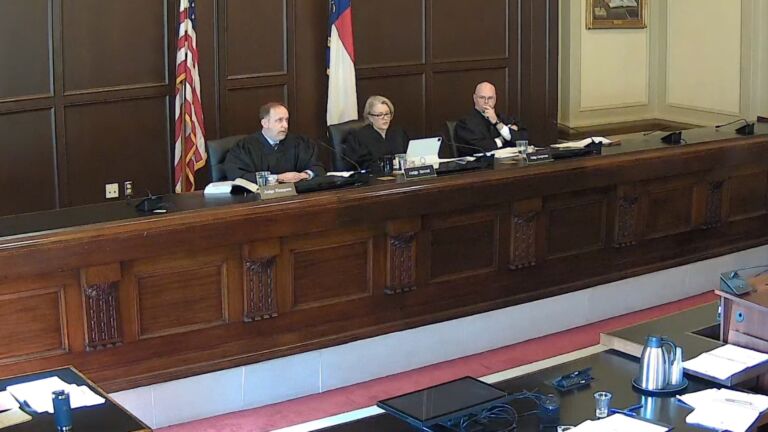 Judges Tobias Hampson, Donna Stroud, and Jeff Carpenter on the Appeals Court bench