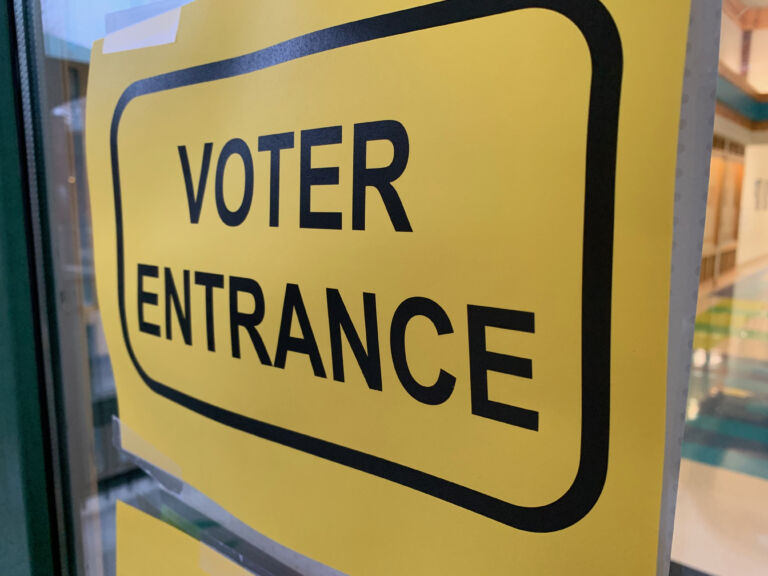 Yellow voter entrance sign