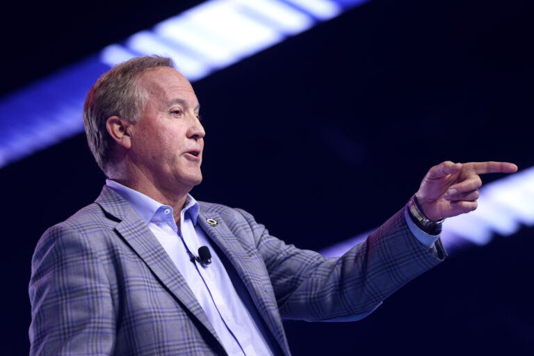 Ken Paxton points finger while speaking on stage