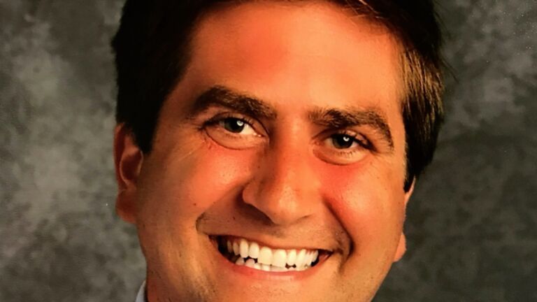 Scott Lassiter smiles in headshot